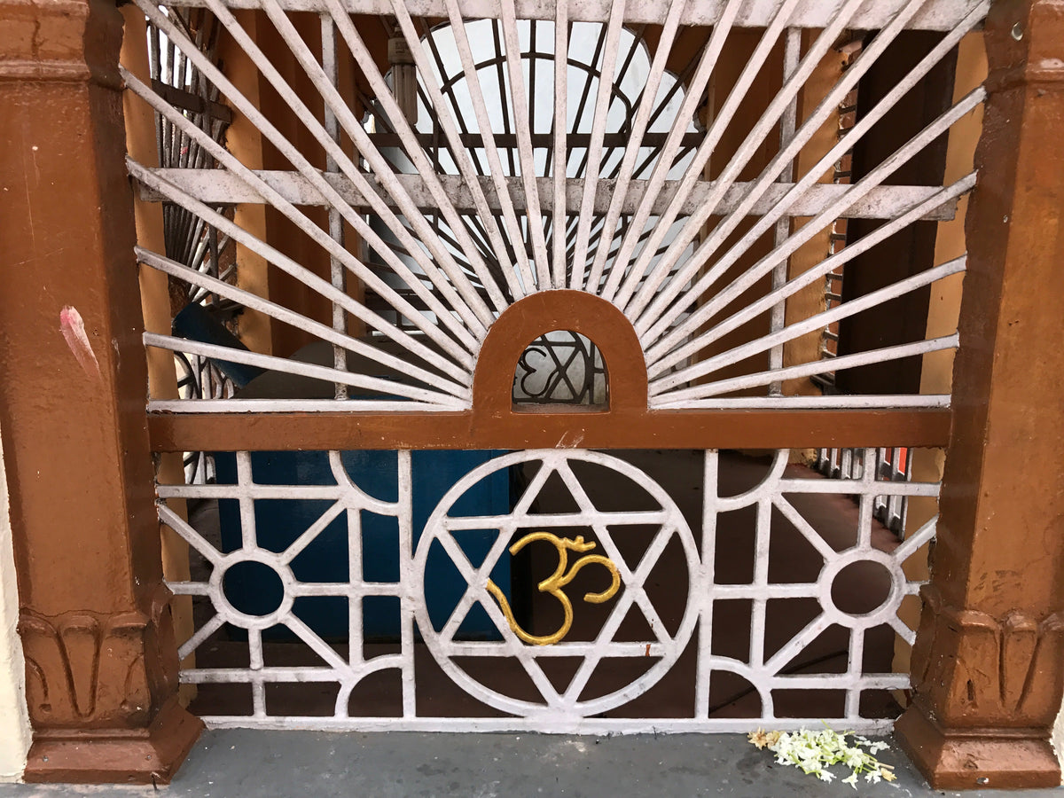 Om symbol displayed inside a historic Hindu temple in Kerala