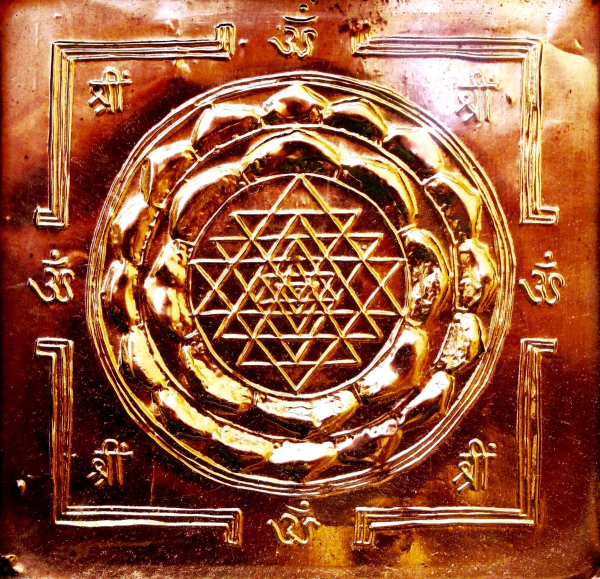 Copper Sri Yantra relief with interlocking triangles, lotus rings and an outer square